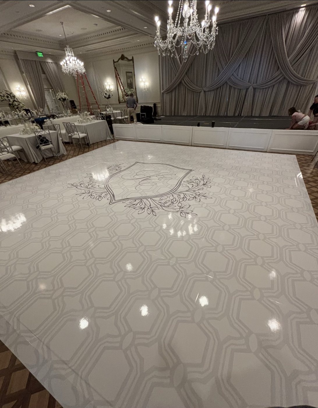 White high-gloss dance floor wrap with a custom crest monogram and lattice pattern at Myers Park Country Club, Charlotte
