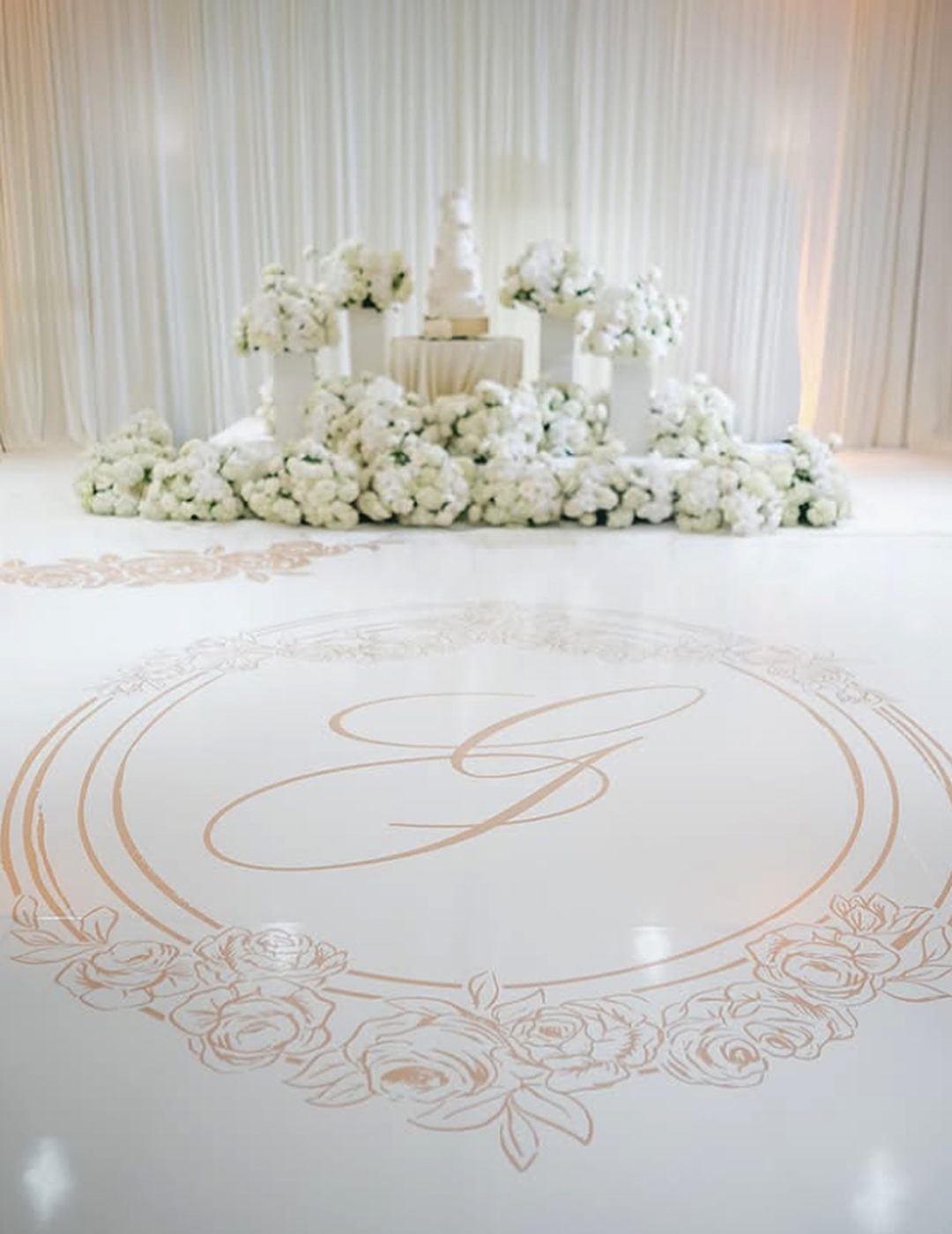 Gold monogram in a rose wreath on a white dance floor wrap at The Ritz-Carlton, Atlanta